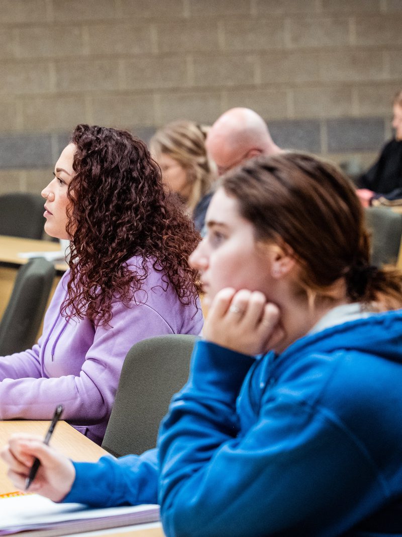 Students listening from the front row of a general education class